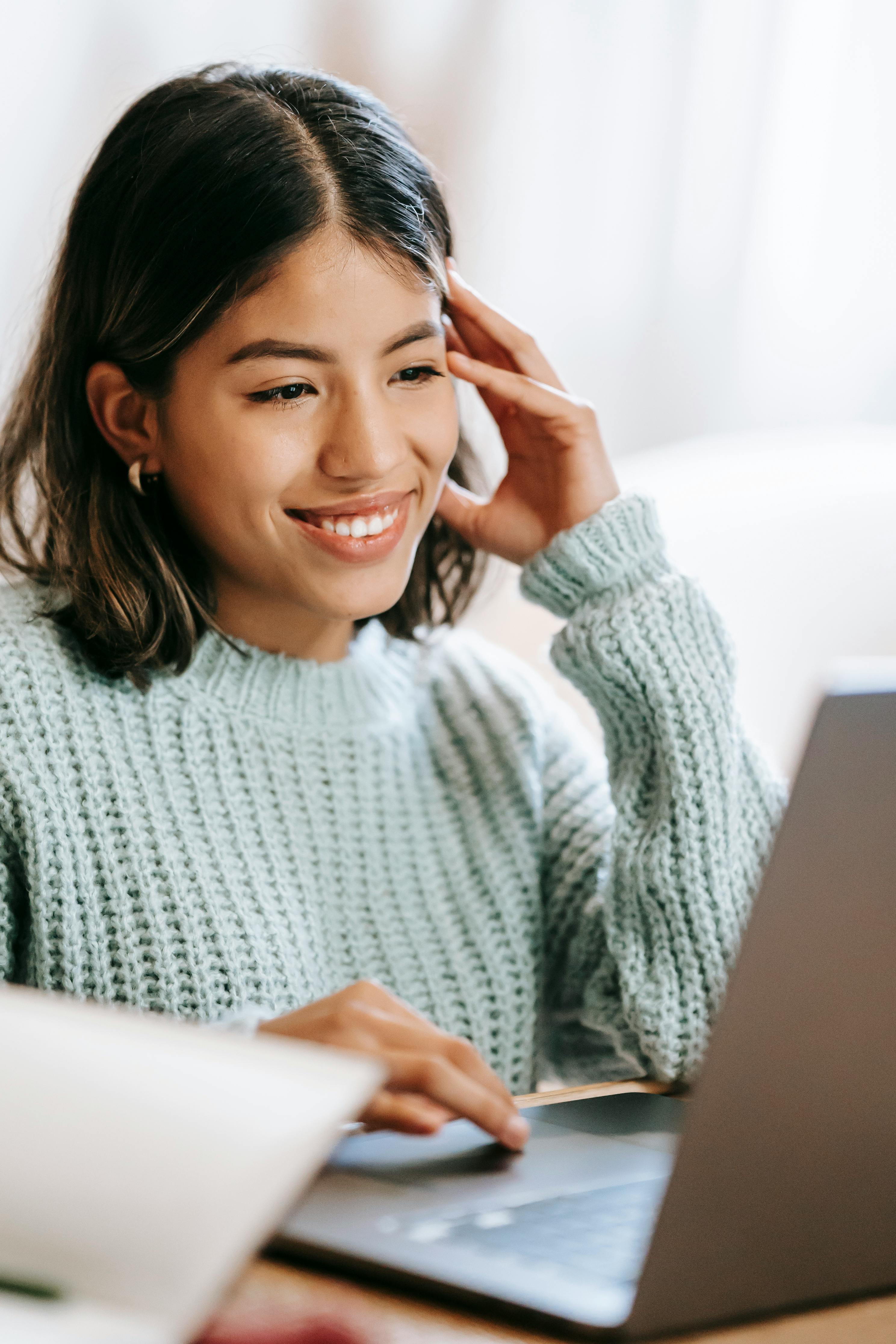 Image of lady smiling at her laptop